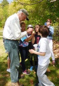 Students gather seeds for a germination project with naturalist Ted Watt at Russell Elementary. (Photo by Amy Porter)