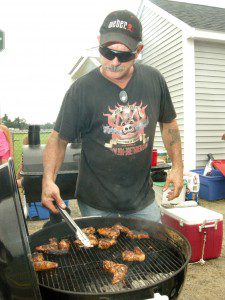 Bob Oleksak of the Smokey O's team, sponsored by the Butcher Block of Westfield, grills chicken last year at the annual Grill'n Daze barbeque competition sponsored by the Southwick Rotary Club. The Smokey O's took third place for the chicken and also for their chili but took first place for their pork entry. (File photo ©2012 Carl E. Hartdegen)