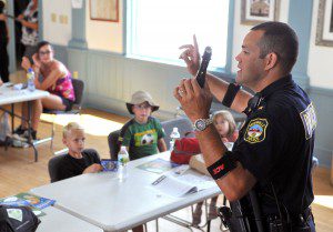 Granville Police Chief Jose Rivera explains some of the police items that are normally carried by law enforcement personnel as part of the Granville Junior Police Academy at the Granville Town Hall Community Room yesterday. (Photo by chief photographer Frederick Gore)