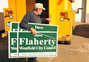 Westfield Department of Public Works employee Earl Sprague unloads an armful of political signs prior to the 2011 election.  (File photo by chief photographer Frederick Gore)