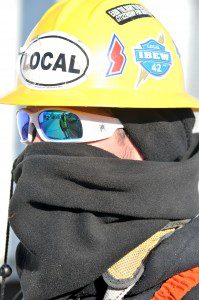 A contractor attempts to stay warm during cold weather. (Photo by chief photographer Frederick Gore)