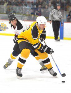 Black & Gold Legends' Scott Young gets out in front of Westfield Fire Department's P.J. Hoynoski during the annual charity ice hockey game at Amelia Park Ice Arena in 2013. (Staff Photo)