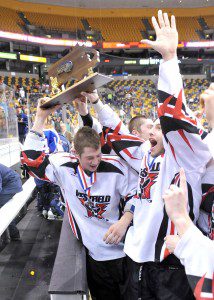 Members of the Westfield High School ice hockey team rejoice while holding the MIAA Ice Hockey State Division III trophy after Sunday's game with Swampscott at the TD Garden in Boston. Westfield won 4-1. (Photo by chief photographer Frederick Gore)