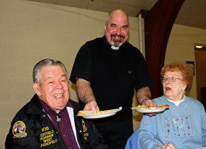 Friday night was another Lenten dinner offered by St. Joseph Church. Every Friday during Lent the church served a different meat-free dinner to all who attended. Father Sr. Joseph Soltysiak, served church members Bob & Helene Parsons. (Photo by Don Wielgus)