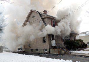 Smoke billows yesterday from a house located at 21 High Street in Westfield. (Photo submitted by Westfield Police)