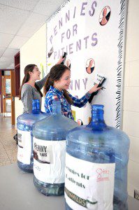 Westfield Middle School South Builders Club members, Miranda Boudreau, rear, and Mary Philpott, work on a wall display for the school-wide "Pennies for Patients" fundraiser. Proceeds of the month-long event will benefit leukemia research. (Photo by chief photographer Frederick Gore)