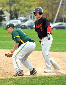 Southwick first baseman Nick Fortini, left, holds Westfield base runner Kyle Murphy on base. (Photo by Frederick Gore)