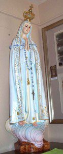 A rosary which had been draped on a smaller-than-life-sized statue of Our Lady of Fatima in the entrance to St. Mary's Church is missing and city police are requesting help from the public to recover the rosary made of blue beads. (Photo courtesy the Westfield Police Department)