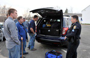 Granville Police Sgt. Patrick Winslow, right, explains some of the emergency equipment carried by police officers during a hands-on demonstration in the Granville police station parking lot Wednesday as part of a Granville Citizens Police Academy class. (Photo by Frederick Gore)
