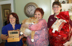 Andrew Grant Diamond Center and For K-9s & Felines, both located in The Yankee Village Plaza in Westfield, recently finished their Cutest Pet Facebook Contest.  Pictured is the winner, Louie, with his mom, Pat Bettinger.  Lynne Davis from Andrew Grant shows an exotic wood jewelry box on the left for Pat, and Nicoll Vincent , right, owner of For K-9s & Felines, stands with an overstuffed gift basket for Louie. With 154 votes, Louie bested 72 other entries for The 'Cutest Pet' title.  (Photo by Don Wielgus)  