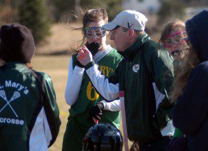 St. Mary girls' lacrosse coach Dave Watson instructs his players during a break in the action Wednesday against Cathedral at Spec Pond Field in Wilbraham. (Photo by Chris Putz)
