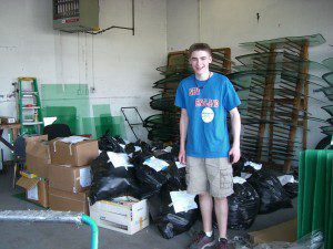 Jonathan Huntley stands with 53 bags of donations.  (Photo submitted)