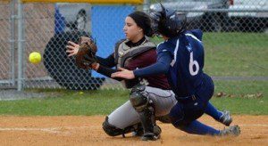 Molly Dunbar executes an excellent slide around RIC catcher Tori Lussier to score the game-winning run. (Photo by Nick Villante)
