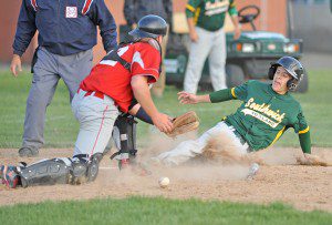 Southwick Brian Sheil, right, slides safely into home after Hampshire Regional's catcher loses the ball, foreground center. (Photo by Frederick Gore)