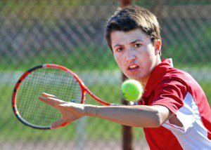 Westfield No. 1 singles Loeiz Briand eyes the ball during yesterday's match with Amherst No. 1 James Kirwan. (Photo by Frederick Gore)