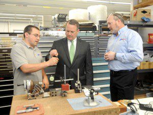Lt. Gov. Timothy Murray is flanked by Scott Laprade, marketing manager at Genevieve Swiss Industries, and Scott Barbanel, the company's controller, as he examines one of the company's products during a tour of the Westfield business yesterday. (Photo by Carl E. Hartdegen)