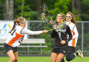 Westfield's Mary Boudreau, right foreground, battles a pair of Belchertown defenders during Friday night's game at Belchertown. (Photo by Frederick Gore)