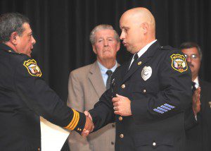 Westfield Police Officer Frank Gaulin accepts a Medal of Valor from Chief John Camerota as Police Commissioners Karl Hupfer and Felix Otero look on Thursday evening at a police awards ceremony at Westfield Middle School South. (Photo by Carl E. Hartdegen)