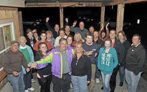 Joe Deedy, front center, holds his wife Kristi, after winning Tuesday night's selectmen race in Southwick. Well-wishers gathered at the Moo-Licious Farm for the celebration. (Photo by Frederick Gore)