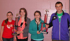 Photos (Left) Alissa Williams, Morganne Warner, Anna Pless and Brennan Foley display the instrumental music trophies. (photo submitted)