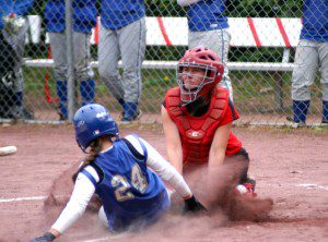 Westfield High School softball catcher Katelyn Puza applies the tag for an out against West Springfield at home plate.