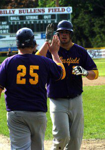 Westfield Voc-Tech's Chris Oberther (26) is congratulated by teammate Tyler French (25). (Photo by Chris Putz)