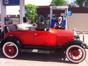 Tim McAneany of Westfield fills the tank of his Model-A Ford recently.  (Photo submitted)