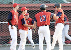 Westfield American Legion Post 124 outfielder Ryan Tettemer, right, is congratulated by his team during Friday night's game against visiting East Springfield Post 420. Tettemer scored the first run of the night. (Photo by Frederick Gore)