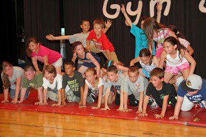Third grade students building a human pyramid as the grand finale. (Photo by Don Wielgus)