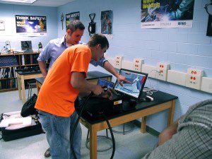 Seth Short (left) gives a technique pointer to Gateway student Dalton Spaeth, as he takes a shot at using the welding simulator. (Photo submitted) 