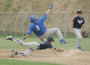 Westfield South base-runner David Tirrell, (9), collides with Northampton second baseman Patrick Serio, foreground, during last night's game at Paper Mill Field. (Photo by Frederick Gore)