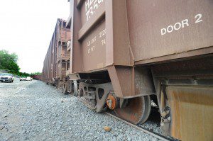 The wheels of a railroad car rest on the trap rock of the rail bed at the John S. Lane and Son railroad siding after five cars of a 49-car train, each loaded with 100 tons of trap rock, derailed while it was begin assembled yesterday afternoon. No injuries were reported and the accident did not create a hazard for the public. (Photo by Carl E. Hartdegen) 