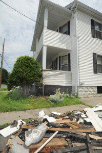 A plaster angel is among the debris removed from the porch of a two family house on White Street which was damaged by fire Friday afternoon. (Photo by Carl E. Hartdegen)