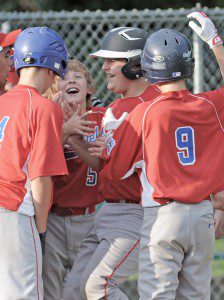 Westfield catcher Joe Raco, center right, is congratulated after slamming a home run over the right field fence during last night's game against Northampton. (Photo by Frederick Gore)