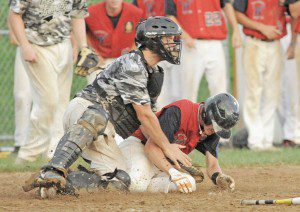 Westfield Post 124 Ryan Tettemer, right, collides with South Hadley catcher Michael Croke causing a controversial call at home plate. Tettemer was declared out. (Photo by Frederick Gore)