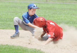 Westfield South's Matt Pelletier, left, slaps the tag on North baserunner Walter Figeroa. (Photo by Frederick Gore)