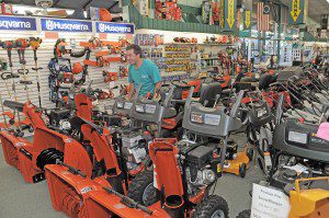 Travis Modlish, a sales associate at Westfield Home and Garden / Agway on Route 20 in Westfield, arranges a row of snow blowers and other lawn and tractor equipment in preparation of the upcoming tax free weekend Aug 10 and 11. The sales-tax free holiday weekend applies to retail sales excluding any single item priced higher than $2,500. (Photo by Frederick Gore)