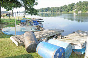 An estimated 6,000 pounds of old abandoned docks, plastic barrels and even a fiberglass boat, center, were collected by volunteers and Southwick Lake Management officials in an effort to maintain a clean and safe lake. Officials said homeowners around Congamond Lake would leave their submerged docks and other debris in the water making it unsafe for recreational skiers, swimmers, and boaters. The debris was scheduled to be removed by the Southwick Department of Public Works. (Photo by Frederick Gore)