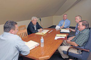 Laurence Shaffer, second from left, of Larry Shaffer Associates Municipal Solutions, of Mount Pleasant, Michigan, David A Swirk, second from right, project manager of safety and training for Pioneer Valley Railroad, and Daniel W. Slowick, right, a fire consultant for Rimkus Consulting Group, of Framingham, join Westfield Mayor Daniel Knapik, center rear, and Westfield City Advancement Officer Jeffrey Daley, left foreground, during a meeting at 27 Washington Street to assist Palmer officials in a downtown revitalization program for their town. (Photo by Frederick Gore)