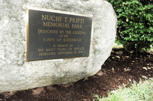 A bronze plaque mounted on a large stone in the center of Prifti Park is a remembrance of former Southwick Selectman Nuchi T. Prifti. (Photo by Frederick Gore)