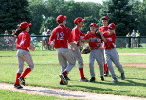Westfield North's 12-Year-Old All-Star players Luke Bacopoulous (4), Nick Barber (12), Carter Cousins (10), Mike Hall (11), and Spencer Cloutier (9) congratulate pitcher Jimmy Hagan (3), after he recorded the final strikeout to win the District II championship Sunday. (Submitted photo)