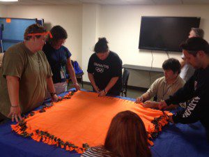 On Saturday, July 21, the Westfield State Alumni Association made blankets to donate to Shriners Hospital during their annual retreat weekend. From the left: President Kelli Nielsen, class of '04, Angela Vatter, class of '93, Cheryl Vieira, class of '08, Ben Swartz, class of '09, and Ryan O'Connell, class of '08. (Photo taken by Suzanne Boniface, class of '92) 