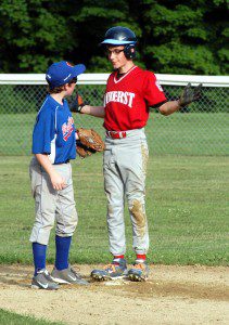 An Amherst baserunner motions to Westfield Little League Majors South All-Stars second baseman Scotty Bussell after reaching base safely in the bottom of the second inning Tuesday night. (Photo by Chris Putz)