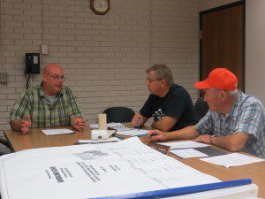 Kevin Soper of the Water Department, left, speaks to water commissioners David Meczywor and Chairman Luther Hosmer about a leaking pipe problem on Wynnfield Circle, (Photo by Hope E. Tremblay)