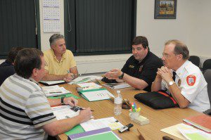 Southwick Fire Department Lt. Scott Bradbury, second from right, and Southwick Fire Chief Richard Anderson, right, explain to the Southwick Selectmen how a Safer Grant could benefit the department by employing a full time assistant firefighter who would help guide the department in day-to-day operations. (Photo by Frederick Gore)