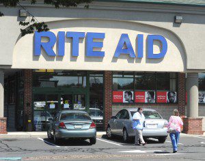 A Rite Aid employee was posted outside the East Main Street store Friday morning to divert customers from the store which was closed for a time after an armed robber stole narcotics from the store’s pharmacy. (Photo by Carl E. Hartdegen)
