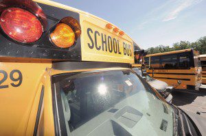A line of Southwick-Tolland-Granville Regional School buses are cleaned and prepped for opening day Wednesday. (Photo by Frederick Gore)