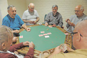 A group of men stay active with a friendly card game at the Southwick Senior Center. (Photo by Chief Photographer Frederick Gore)