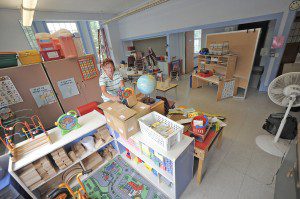 Linda Blakesley, a secretary at the Granville Village School, helps arrange the preschool room yesterday where Southwick Granville and Tolland preschool students will attend. (Photo by Frederick Gore)