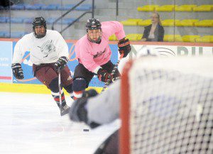 Clap Bomb Crew's Nick Sibilia, right, moves the puck into scoring position as Northern Tree goalie Luke Lepine watches during Round 2 of the Kevin Major Ice Hockey Tournament last night at the Amelia Park Ice Arena. (Photo by Frederick Gore)